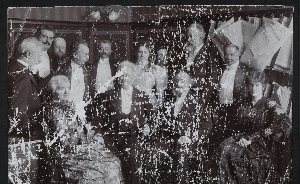 Severely creased and scratched group photograph before and after AI restoration