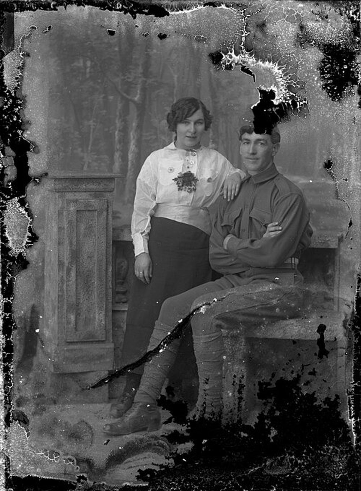 Before: 1914 studio portrait of a couple — heavy edge emulsion-loss, tears and stains repaired